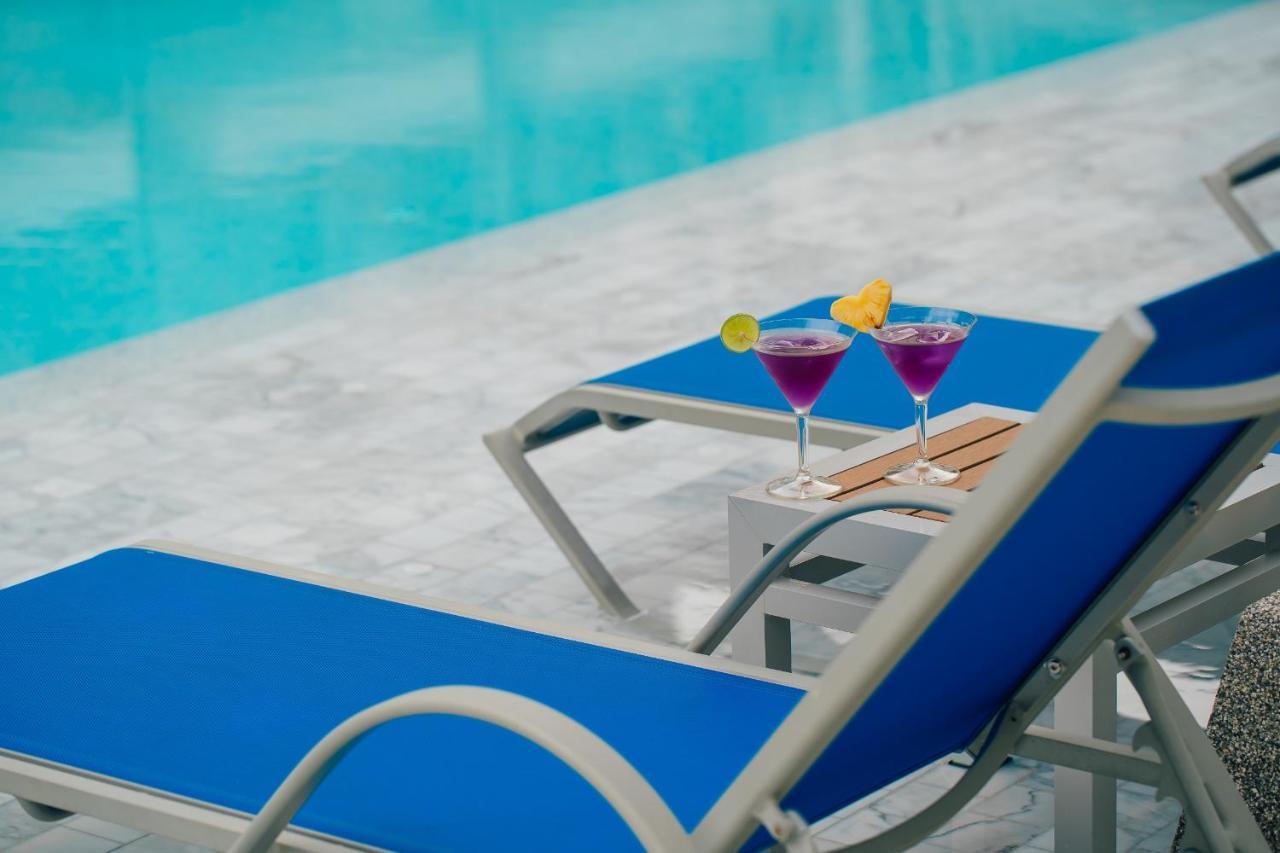 Seabed Grand Hotel Phuket - Sha Extra Plus Exterior photo A poolside table