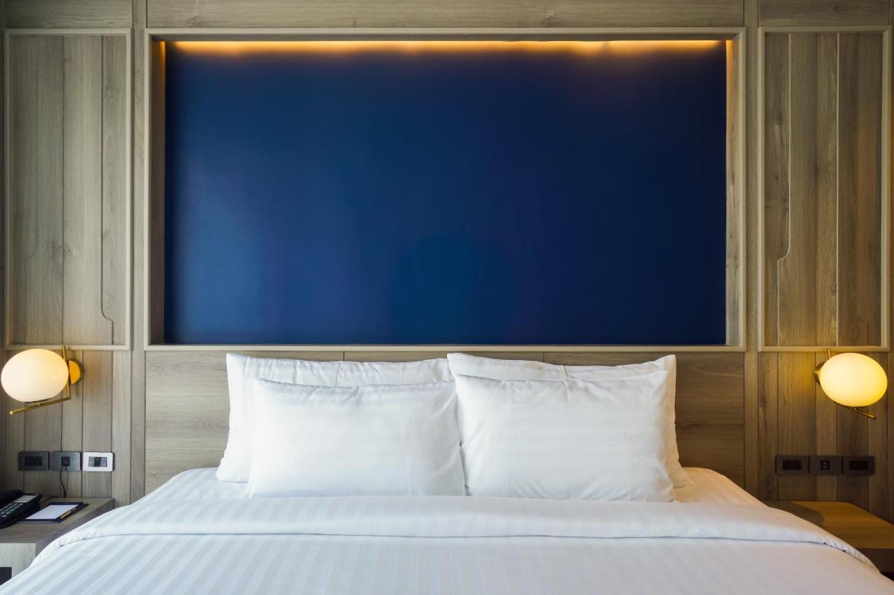 Seabed Grand Hotel Phuket - Sha Extra Plus Exterior photo A bed with two pillows